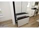 Modern kitchen with a white refrigerator, open drawers and beautiful light wood floors at 1005 Whistler St, Durham, NC 27713