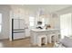 Bright, modern kitchen with white cabinets, stainless steel appliances, a center island with seating, and stylish pendant lighting at 1005 Whistler St, Durham, NC 27713