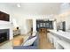 Open-concept living space showcasing a fireplace, comfortable seating, and seamless flow to the adjacent kitchen and dining areas at 1005 Whistler St, Durham, NC 27713
