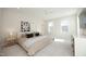 Spacious main bedroom featuring large windows, neutral tones, plush carpet, and modern decor at 1005 Whistler St, Durham, NC 27713