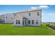 Exterior view of a home with a covered porch, lush green lawn, and fenced backyard at 101 Hiddenite Pl, Holly Springs, NC 27540