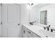 Modern bathroom with double vanity, marble countertop, and a large mirror with contemporary lighting at 101 Hiddenite Pl, Holly Springs, NC 27540