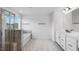 Bright bathroom featuring a walk-in shower with tile surround, a soaking tub, and double vanities at 101 Hiddenite Pl, Holly Springs, NC 27540