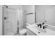 Bright bathroom with a glass-enclosed shower, modern vanity, and sleek black fixtures at 101 Hiddenite Pl, Holly Springs, NC 27540