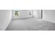 Spacious bedroom with neutral carpet, two windows with blinds and white trim, and a view of the neighborhood at 101 Hiddenite Pl, Holly Springs, NC 27540