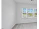 Bright bedroom with neutral carpet and a large window offering plenty of natural light and neighborhood views at 101 Hiddenite Pl, Holly Springs, NC 27540