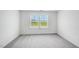 Bright bedroom with plush carpet and double windows, creating a comfortable and inviting space at 101 Hiddenite Pl, Holly Springs, NC 27540