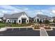 Exterior view of the community clubhouse with modern farmhouse design and landscaping at 101 Hiddenite Pl, Holly Springs, NC 27540