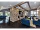 Spacious common area with a fireplace, dining table, and comfortable seating arrangements at 101 Hiddenite Pl, Holly Springs, NC 27540
