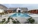 Beautiful community pool featuring a zero-entry access, a clubhouse, and shaded seating at 101 Hiddenite Pl, Holly Springs, NC 27540