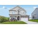 Charming two-story home with brick and siding, featuring a well-maintained lawn and attached two-car garage at 101 Hiddenite Pl, Holly Springs, NC 27540