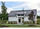 Inviting entrance with stone accents, a metal roof, and well-maintained landscaping at 101 Hiddenite Pl, Holly Springs, NC 27540