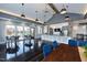 Spacious community lounge with modern lighting fixtures, dining tables, and a kitchenette at 101 Hiddenite Pl, Holly Springs, NC 27540