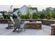 Inviting outdoor space with a stone fireplace and comfortable Adirondack chairs at 101 Hiddenite Pl, Holly Springs, NC 27540