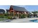 Poolside pavilion featuring wood beams, a metal roof, and seating for outdoor entertaining at 101 Hiddenite Pl, Holly Springs, NC 27540