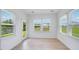 Bright sunroom with multiple windows and a glass door, offering natural light and views of the outdoors at 101 Hiddenite Pl, Holly Springs, NC 27540