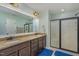 This bathroom has double sinks, granite countertops and a walk-in shower with glass doors at 1018 Tranquil Creek Way, Wake Forest, NC 27587