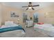 Bright bedroom with two twin beds, neutral walls, and a ceiling fan at 1018 Tranquil Creek Way, Wake Forest, NC 27587