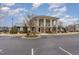 Exterior view of the community clubhouse with stone accents and ample parking at 1018 Tranquil Creek Way, Wake Forest, NC 27587