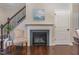 Cozy fireplace with decorative chair and painting of a sailboat above the mantle at 1018 Tranquil Creek Way, Wake Forest, NC 27587