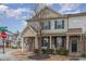 Charming townhome features a stone facade, inviting front porch, and well-manicured landscaping at 1018 Tranquil Creek Way, Wake Forest, NC 27587