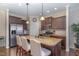 Well-equipped kitchen with stainless steel appliances, granite countertops, and wooden cabinets at 1018 Tranquil Creek Way, Wake Forest, NC 27587