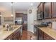 This kitchen is equipped with stainless steel appliances, wooden cabinets, and granite countertops at 1018 Tranquil Creek Way, Wake Forest, NC 27587