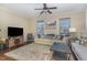 Inviting living room with hardwood floors, plush rug, comfortable seating and lots of natural light at 1018 Tranquil Creek Way, Wake Forest, NC 27587