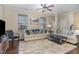Inviting living room with hardwood floors, plush rug, comfortable seating and lots of natural light at 1018 Tranquil Creek Way, Wake Forest, NC 27587