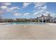 Community pool is surrounded by lush landscaping, lounge chairs, and a clubhouse at 1018 Tranquil Creek Way, Wake Forest, NC 27587