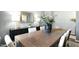 Elegant dining room with a wooden table, statement artwork, and contemporary lighting at 102 Saddle Mare St, Clayton, NC 27520