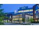 Modern UNC Health Care building with glass facade, manicured landscaping, and well-lit entrance. State-of-the-art healthcare facility at 1024 Zelkova Lane, Chapel Hill, NC 27517