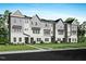 Attractive townhouses with a combination of light gray and white exteriors, complimented by a well-maintained lawn at 1026 Zelkova Lane, Chapel Hill, NC 27517