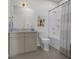 Well lit bathroom with modern vanity, toilet, bathtub and shower with gold hardware at 1033 Zelkova Lane, Chapel Hill, NC 27517