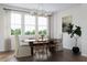 Inviting dining room with natural light, an elegant chandelier, and stylish modern furniture at 1033 Zelkova Lane, Chapel Hill, NC 27517