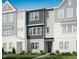 New townhouse boasts a modern facade, neutral palette, and manicured lawn at 1033 Zelkova Lane, Chapel Hill, NC 27517
