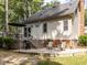 Inviting back patio with a grill, seating, and a deck, ideal for outdoor entertaining and relaxation at 104 Pinecroft Dr, Raleigh, NC 27609
