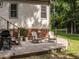 Backyard patio featuring Adirondack chairs, a grill, and a view of the expansive green lawn at 104 Pinecroft Dr, Raleigh, NC 27609