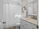 Clean bathroom featuring a shower with a tile surround and a vanity with stone countertops at 104 Pinecroft Dr, Raleigh, NC 27609