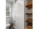 Bathroom featuring a toilet, floating shelves, and a stylish sliding barn door at 104 Pinecroft Dr, Raleigh, NC 27609