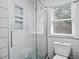 Modern bathroom with a glass-enclosed shower, white subway tile, and geometric tile accent niches at 104 Pinecroft Dr, Raleigh, NC 27609