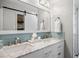 Bright bathroom featuring a double vanity with marble countertop and sliding barn door at 104 Pinecroft Dr, Raleigh, NC 27609