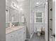 Stylish bathroom featuring a double vanity, subway tile, and a glass-enclosed shower at 104 Pinecroft Dr, Raleigh, NC 27609