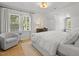 Large primary bedroom featuring hardwood flooring, a large window, and natural light at 104 Pinecroft Dr, Raleigh, NC 27609