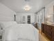Spacious primary bedroom featuring a decorative light fixture and a walk-in closet at 104 Pinecroft Dr, Raleigh, NC 27609