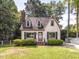 Charming home with manicured lawn, dark shutters, and a brick chimney at 104 Pinecroft Dr, Raleigh, NC 27609
