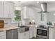 Well-lit kitchen with subway tile backsplash, stainless appliances, and custom cabinets at 104 Pinecroft Dr, Raleigh, NC 27609