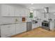 Well-equipped kitchen with stainless appliances, modern hood vent, and custom cabinets at 104 Pinecroft Dr, Raleigh, NC 27609