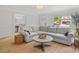 Comfortable living room features an area rug, large couch and natural light at 104 Pinecroft Dr, Raleigh, NC 27609