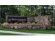 Inviting entrance sign for Bridgeberry in Holly Springs, adorned with stone accents and vibrant landscaping at 109 Hiddenite Pl, Holly Springs, NC 27540